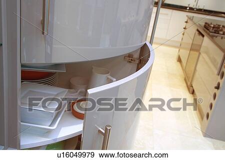 Door half-open on curved kitchen cupboard View Large Photo Image Stock Photo - Door half-open on curved kitchen cupboard. Fotosearch