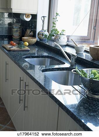 Double sinks in modern kitchen with granite worktop View Large Photo Image Stock Image - Double sinks in modern kitchen with granite worktop. Fotosearch