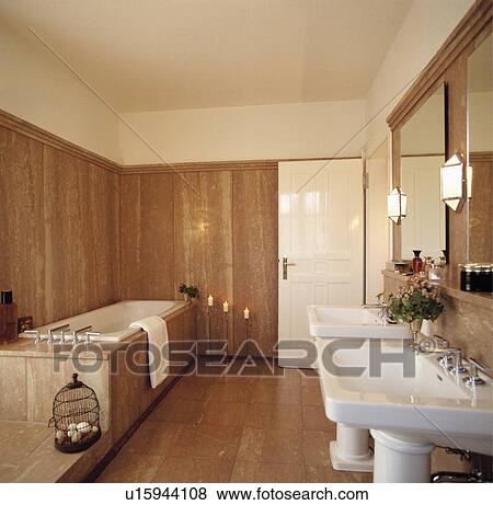 Double white pedestal basins in modern travertine bathroom View Large Photo Image Stock Photo - Double white pedestal basins in modern travertine bathroom . Fotosearch