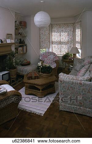 Stock Image - Early Designers Guild sofa and blind in small town living room. Fotosearch