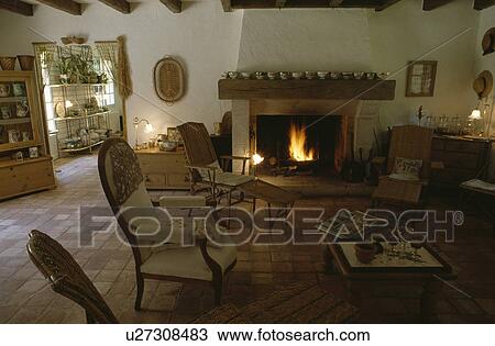 Stock Image - Fireplace in traditional country living room. Fotosearch