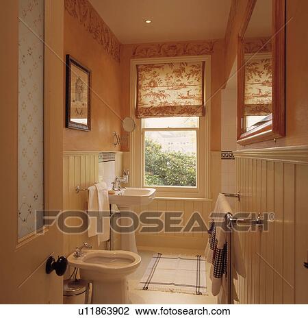 Floral blind on sash window in narrow half-panelled peach bathroom View Large Photo Image Stock Image - Floral blind on sash window in narrow half-panelled peach bathroom . Fotosearch