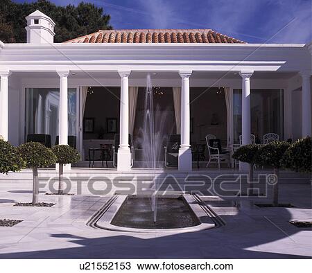 Fountain in courtyard pool in front of Spanish villa View Large Photo Image Stock Image - Fountain in courtyard pool in front of Spanish villa. Fotosearch