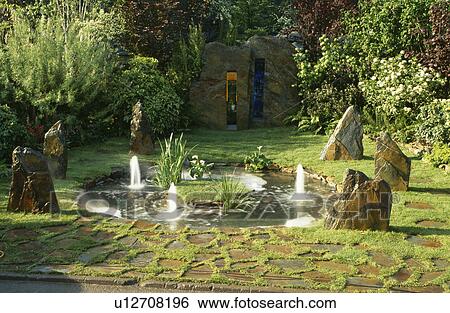 Fountains in small circular pond in country garden View Large Photo Image Stock Photograph - Fountains in small circular pond in country garden. Fotosearch
