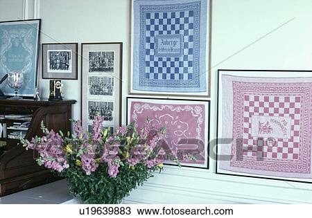 Stock Image - Framed checked napkins on wall. Fotosearch