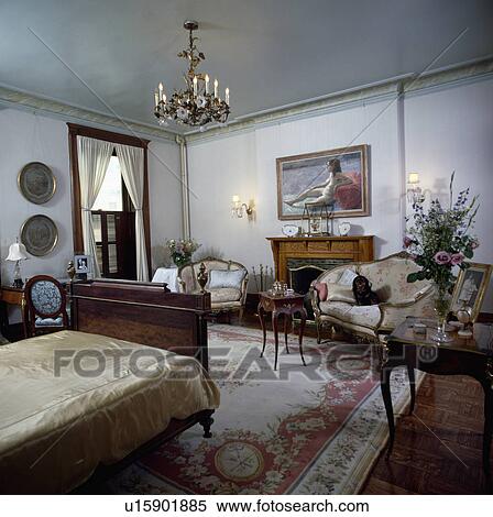 French antique furniture in traditional bedroom with Chinese silk carpet and ornate brass chandelier View Large Photo Image Stock Photography - French antique furniture in traditional bedroom with Chinese silk carpet and ornate brass chandelier . Fotosearch