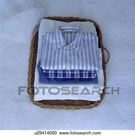 Freshly ironed linen in basket on white table cloth. View Large Photo Image Stock Image - Freshly ironed linen in basket on white table cloth. . Fotosearch