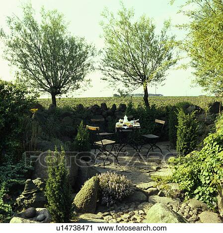 Furniture on patio in country garden in summer View Large Photo Image Stock Image - Furniture on patio in country garden in summer. Fotosearch
