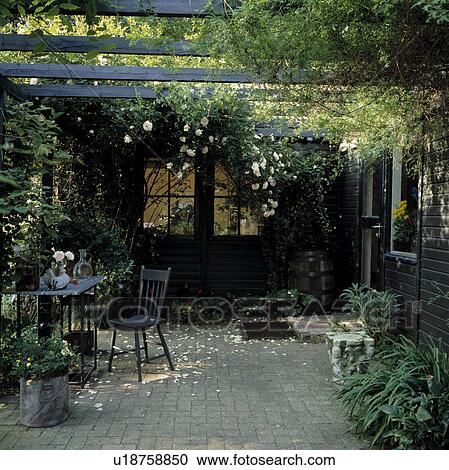 Furniture on patio in town garden in summer View Large Photo Image Stock Image - Furniture on patio in town garden in summer. Fotosearch