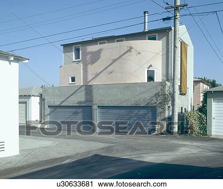 Stock Image - Garages in front of modern Californian townhouse. Fotosearch