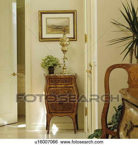 Gilt sculpture on 18th century antique chest of drawers in small cream hall View Large Photo Image Stock Photograph - Gilt sculpture on 18th century antique chest of drawers in small cream hall. Fotosearch