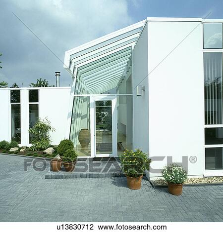 Stock Image - Glass extension on modern white house in the country. Fotosearch
