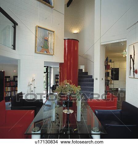 Picture - Glass table and red and black leather armchairs in modern living room. Fotosearch