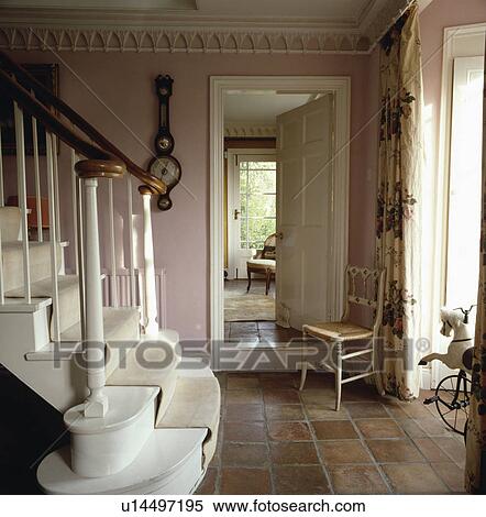 Gothic cornice and small Gothic chair in pink country hall with terracotta tiled floor and white staircase View Large Photo Image Stock Photography - Gothic cornice and small Gothic chair in pink country hall with terracotta tiled floor and white staircase. Fotosearch