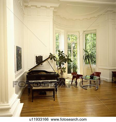 Grand Piano In Traditional Living Room With Wooden Flooring Stock