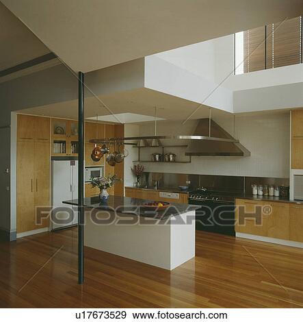 Granite worktop on white island unit in modern white architectural kitchen with wooden flooring View Large Photo Image Stock Photo - Granite worktop on white island unit in modern white architectural kitchen with wooden flooring. Fotosearch