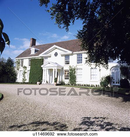 Gravel drive in front of large white traditional house in the country View Large Photo Image Stock Image - Gravel drive in front of large white traditional house in the country. Fotosearch
