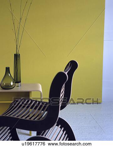 Green vases on fifties style table in dining room green wall and slatted wooden chair  View Large Photo Image Stock Photograph - Green vases on fifties style table in dining room green wall and slatted wooden chair . Fotosearch