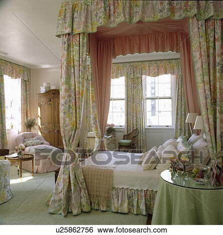 Green+pink floral drapes with pink silk lining on fourposter bed in large country bedroom View Large Photo Image Stock Photograph - Green+pink floral drapes with pink silk lining on fourposter bed in large country bedroom. Fotosearch