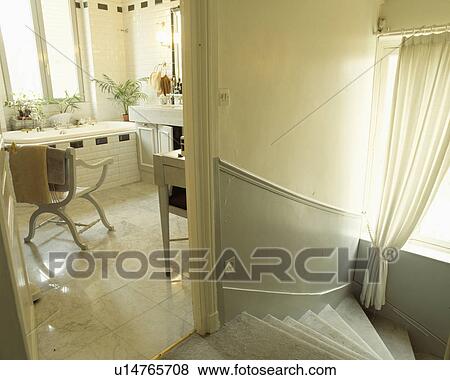 Grey dado panelling on stairs to landing with door open to white bathroom View Large Photo Image Stock Photo - Grey dado panelling on stairs to landing with door open to white bathroom . Fotosearch
