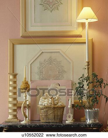 Group of pictures on wall above lighted lamp on shelf View Large Photo Image Stock Image - Group of pictures on wall above lighted lamp on shelf. Fotosearch