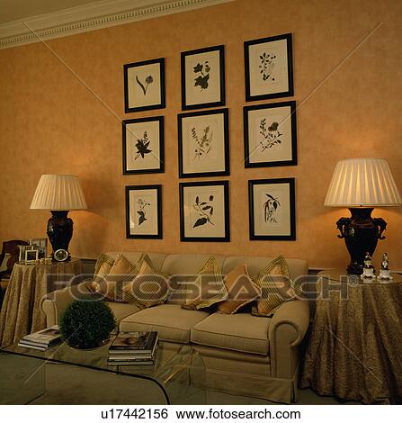 Group of pictures on wall above sofa in traditional living room View Large Photo Image Stock Photograph - Group of pictures on wall above sofa in traditional living room. Fotosearch