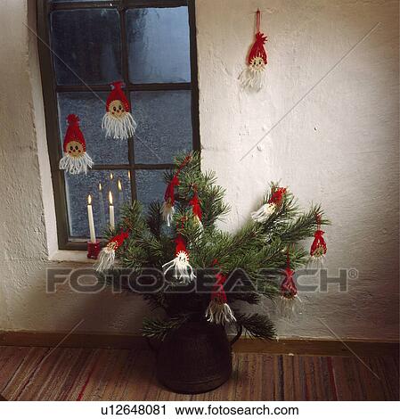 Stock Image - Home-made decorations on pine branches in pot. Fotosearch