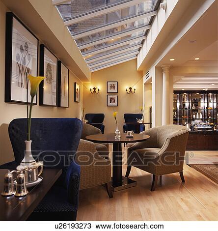Stock Image - Hotel bar with modern glazed extension for informal eating.. Fotosearch