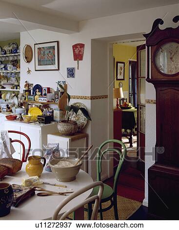 Ingredients for cake-making on kitchen table with green and cream bentwood chairs and longcase clock beside door View Large Photo Image Stock Photo - Ingredients for cake-making on kitchen table with green and cream bentwood chairs and longcase clock beside door. Fotosearch
