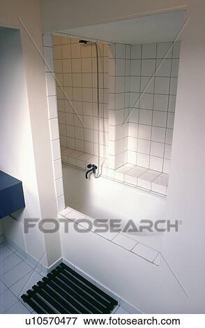 Inset bath and shower in modern white bathroom View Large Photo Image Stock Photo - Inset bath and shower in modern white bathroom. Fotosearch