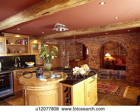 Island unit in barn conversion kitchen with arched doorways in brick wall with view of living room View Large Photo Image Stock Photo - Island unit in barn conversion kitchen with arched doorways in brick wall with view of living room. Fotosearch