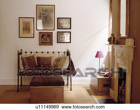 Kelim cushions on small metal settle in uncluttered living room View Large Photo Image Stock Photo - Kelim cushions on small metal settle in uncluttered living room. Fotosearch