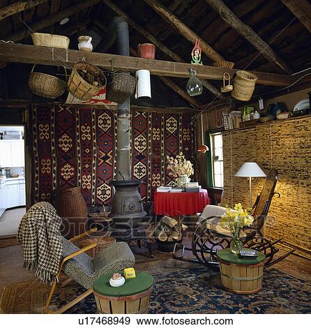 Kelim rug on wall behind stove in rustic country living room View Large Photo Image Stock Photo - Kelim rug on wall behind stove in rustic country living room. Fotosearch
