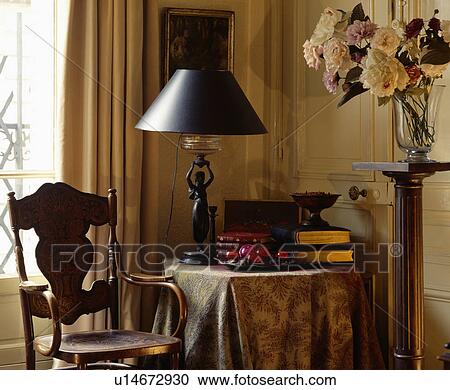 Stock Image - Lamp on table in traditional town living room. Fotosearch