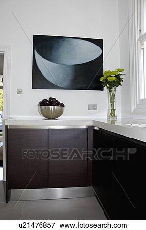Large abstract painting above worktop in modern black & white kitchen with stainless steel kickboards View Large Photo Image Stock Photo - Large abstract painting above worktop in modern black & white kitchen with stainless steel kickboards. Fotosearch