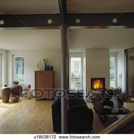 Large amphorae and wooden flooring in modern country living room with lighted fire View Large Photo Image Stock Image - Large amphorae and wooden flooring in modern country living room with lighted fire. Fotosearch