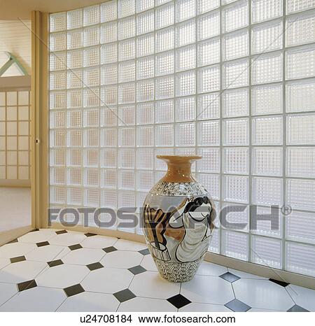 Large classical ceramic pot in front of curved glass brick wall in modern hall with white+black chequerboard floor tiles View Large Photo Image Picture - Large classical ceramic pot in front of curved glass brick wall in modern hall with white+black chequerboard floor tiles. Fotosearch