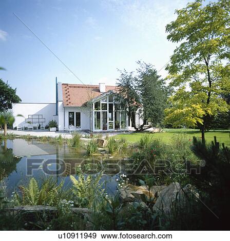 Large detached house in Germany with large pond and lawn. View Large Photo Image Stock Photo - Large detached house in Germany with large pond and lawn.. Fotosearch