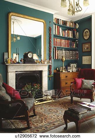 Large Gilt Mirror Above Marble Fireplace In Green Townhosue Living