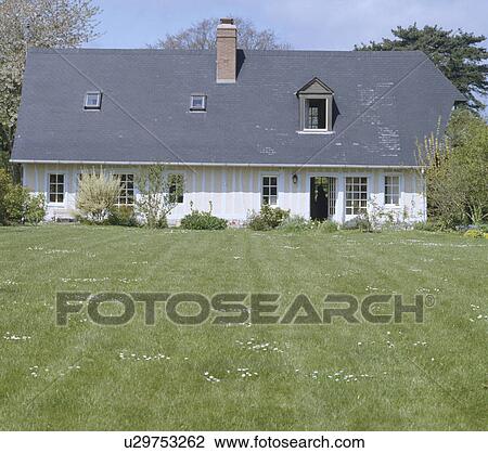 Stock Image - Large lawn in front of country house in summer. Fotosearch