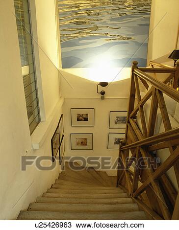 Large picture above staircase with angular wooden bannisters View Large Photo Image Stock Image - Large picture above staircase with angular wooden bannisters. Fotosearch