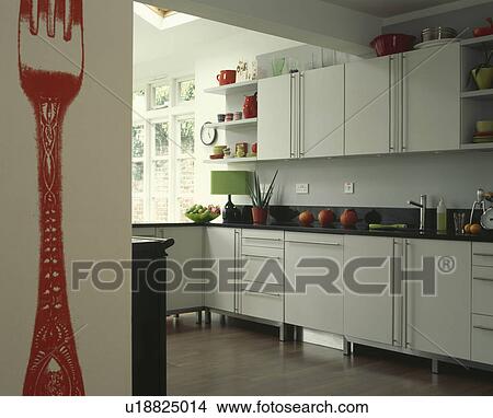 Picture - Large red fork painted on wall on modern kitchen extension. Fotosearch