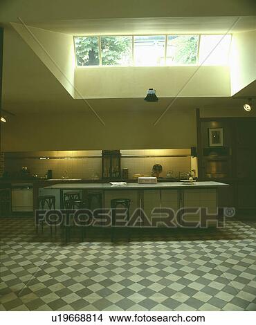 Large skylight above modern kitchen extension with breakfast bar and grey+white chequerboard floor View Large Photo Image Picture - Large skylight above modern kitchen extension with breakfast bar and grey+white chequerboard floor. Fotosearch