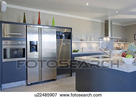 Large stainless steel fridge freezer in modern blue kitchen View Large Photo Image Stock Photo - Large stainless steel fridge freezer in modern blue kitchen. Fotosearch