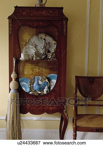 Stock Photo - Large tassel on antique cupboard. Fotosearch