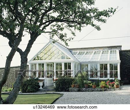 Large walled garden with traditional lean-to Victorian glass conservatory View Large Photo Image Stock Photo - Large walled garden with traditional lean-to Victorian glass conservatory. Fotosearch