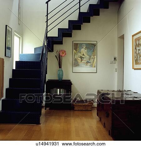 Large wooden chest and black iron stove in modern hall with wooden flooring and black metal staircase View Large Photo Image Stock Image - Large wooden chest and black iron stove in modern hall with wooden flooring and black metal staircase. Fotosearch
