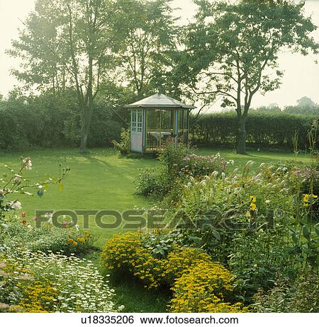 Lawn and summerhouse in summer country garden View Large Photo Image Stock Photograph - Lawn and summerhouse in summer country garden. Fotosearch