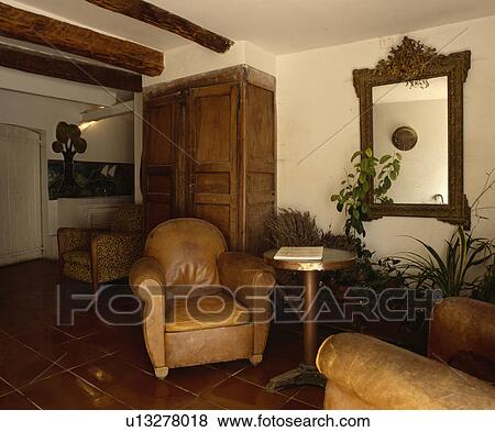 Stock Photo - Leather armchairs in country living room. Fotosearch
