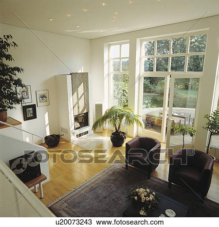 Leather tub armchairs in modern white living room View Large Photo Image Stock Image - Leather tub armchairs in modern white living room. Fotosearch